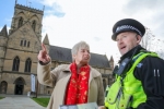 Lia Nici MP (Left) talking to C.I. Dave Stephenson (Right), standing in front of a church.